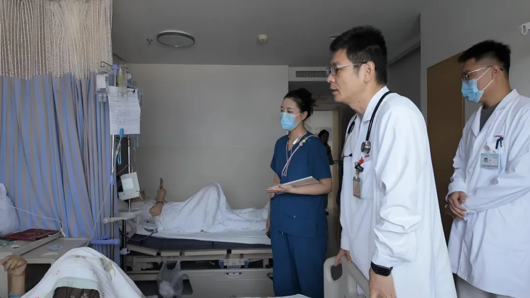 Multidisciplinary breast oncology team at the bedside of a hospitalized patient